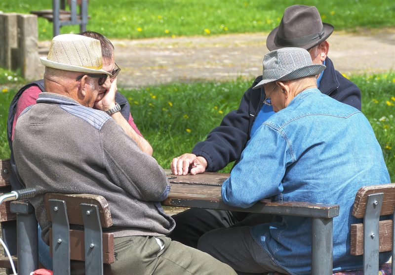 Two older adults sitting together outdoors